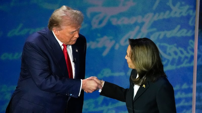Republican presidential nominee former President Donald Trump shakes hands with Democratic...