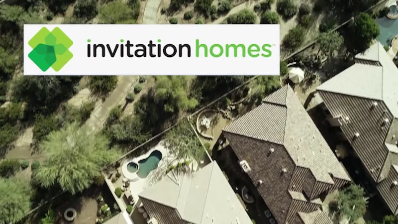 Invitation homes logo in front of generic homes.
