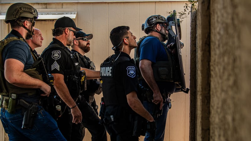 Deputy U.S. marshals and Glendale police officers take part in fugitive apprehension...