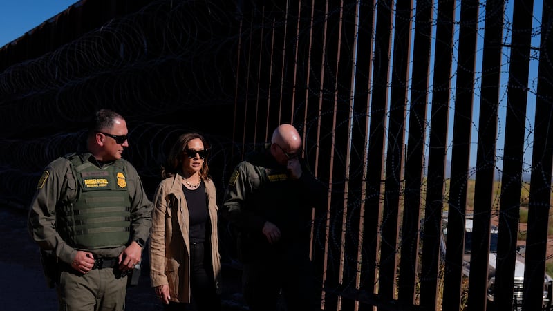 Democratic presidential nominee Vice President Kamala Harris talks with John Modlin, the chief...