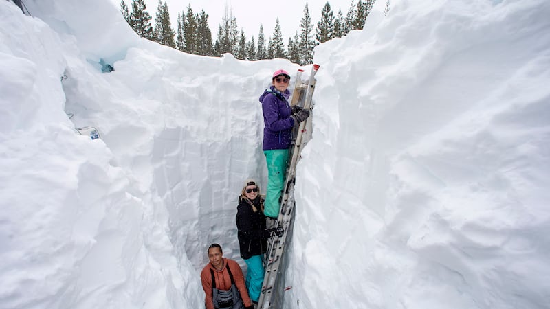 FILE - Working inside a nearly 18-foot-deep snow pit at the UC Berkeley Central Sierra Snow...