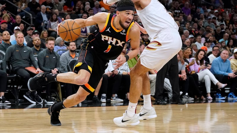 Phoenix Suns guard Devin Booker (1) drives to the basket against Cleveland Cavaliers guard Max...
