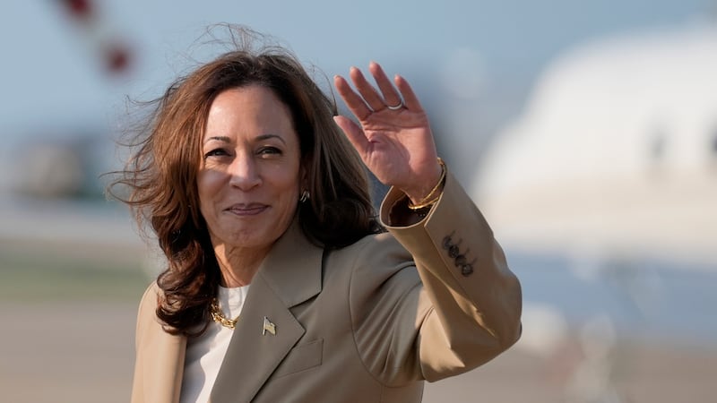 Vice President Kamala Harris waves upon arrival at Andrews Air Force Base in Md., Saturday,...