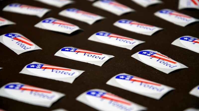 FILE - "I Voted" stickers are displayed at a polling place in Cheyenne, Wyo. on Aug. 16, 2022....