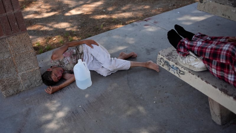 Deb Billet, 66, lies on the ground while Henderson Public Response officers call an ambulance...