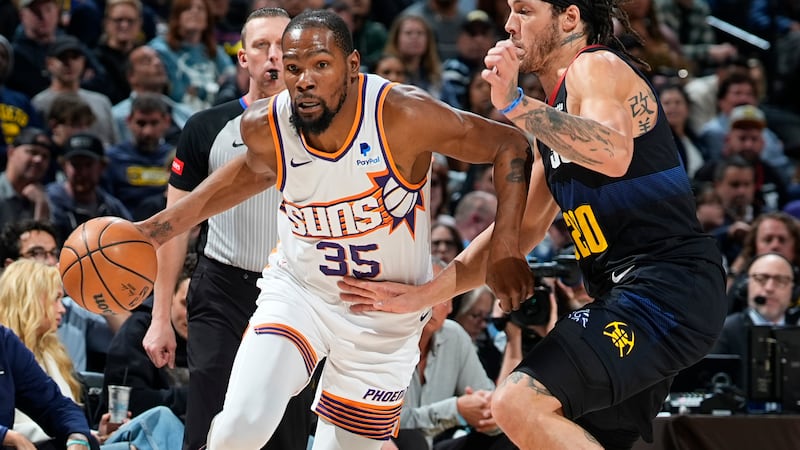 Phoenix Suns forward Kevin Durant drives past Denver Nuggets forward Aaron Gordon during the...