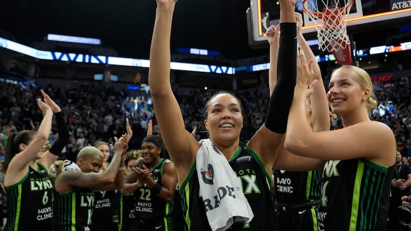Minnesota Lynx forward Napheesa Collier, center, celebrates with teammates after the 88-77 win...