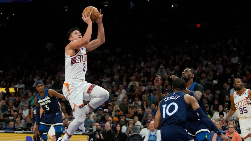 Phoenix Suns guard Grayson Allen (8) goes up to shoot in front of Minnesota Timberwolves guard...