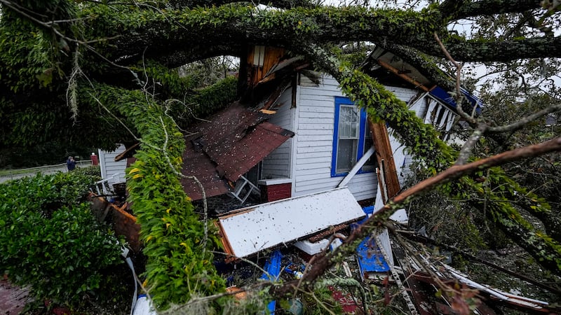 A damaged 100-year-old home is seen after an Oak tree landed on the home after Hurricane...
