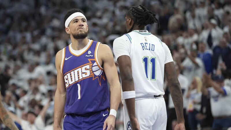 Phoenix Suns guard Devin Booker stands on the court during the second half of Game 1 of an NBA...