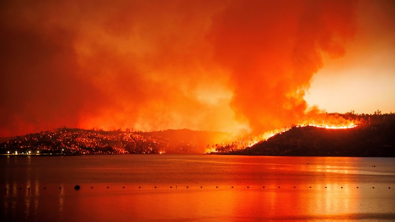 FILE - The Thompson Fire burns along Lake Oroville, Tuesday, July 2, 2024, in Oroville, Calif....