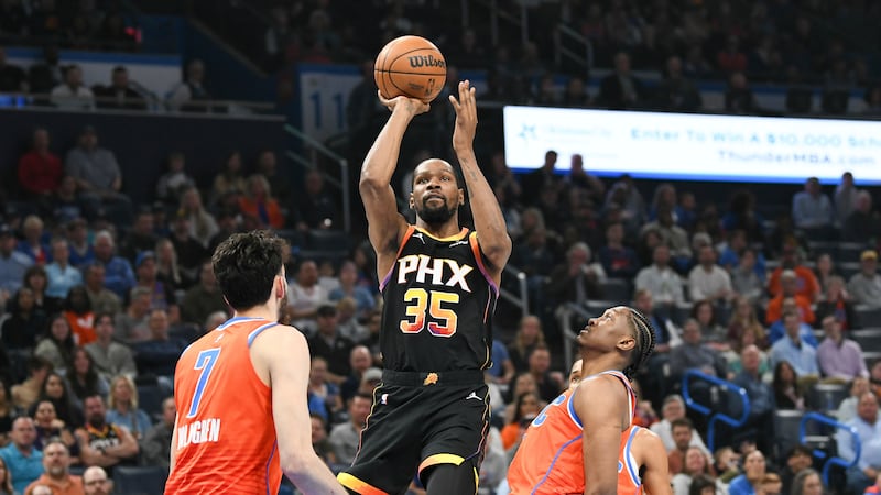 Phoenix Suns forward Kevin Durant, middle, shoots over Oklahoma City Thunder forwards Chet...