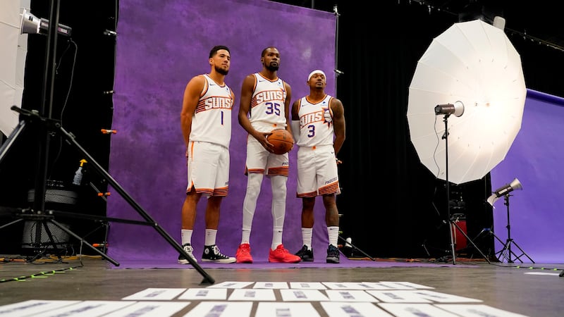 Phoenix Suns' Devin Booker (1), Kevin Durant (35) and Bradley Beal (3) pose for a portrait...